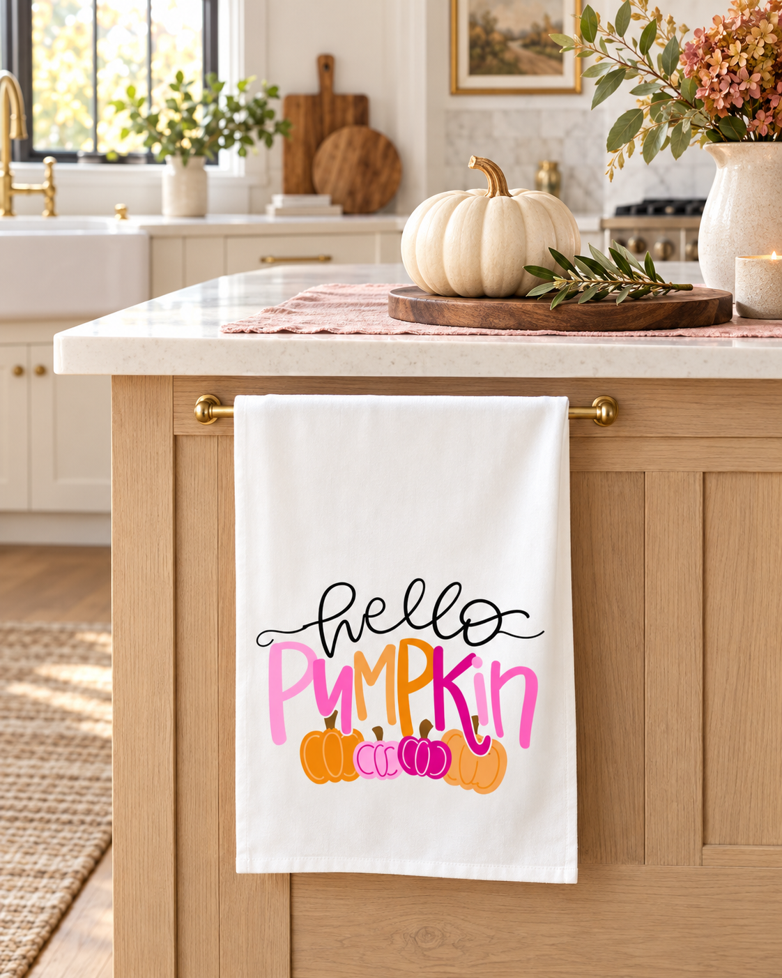 Hello Pumpkin Pink Tea Towel displayed on a light wood kitchen island