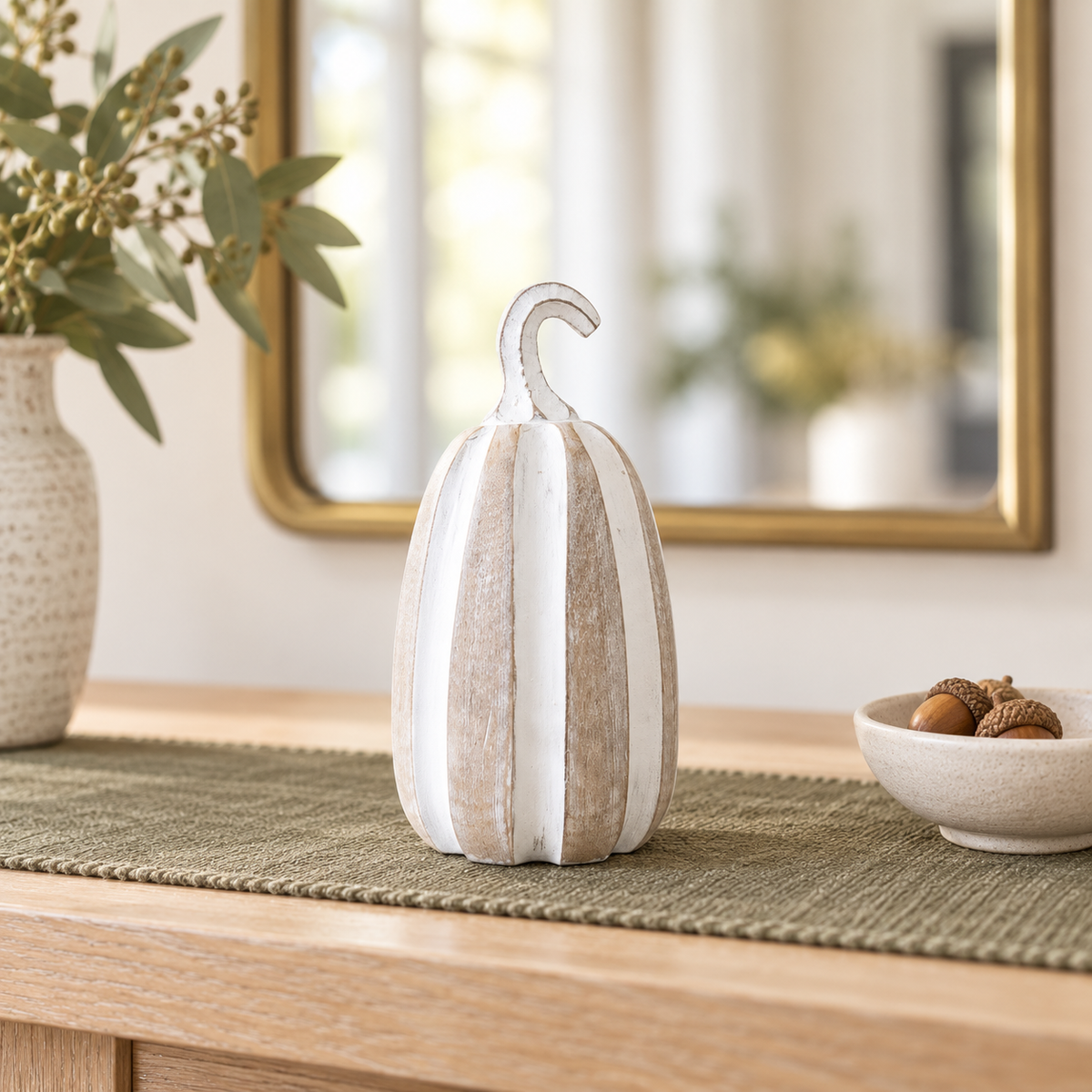 Pippin tall whitewashed pumpkin styled on an olive runner in a fall entryway