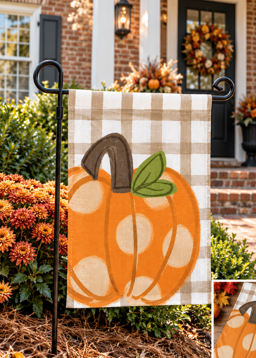Polka dot pumpkin garden flag styled outside a brick home for fall