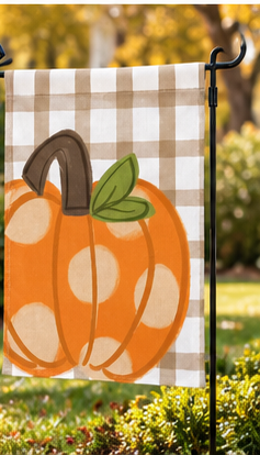 Polka dot pumpkin garden flag displayed outdoors in an autumn garden